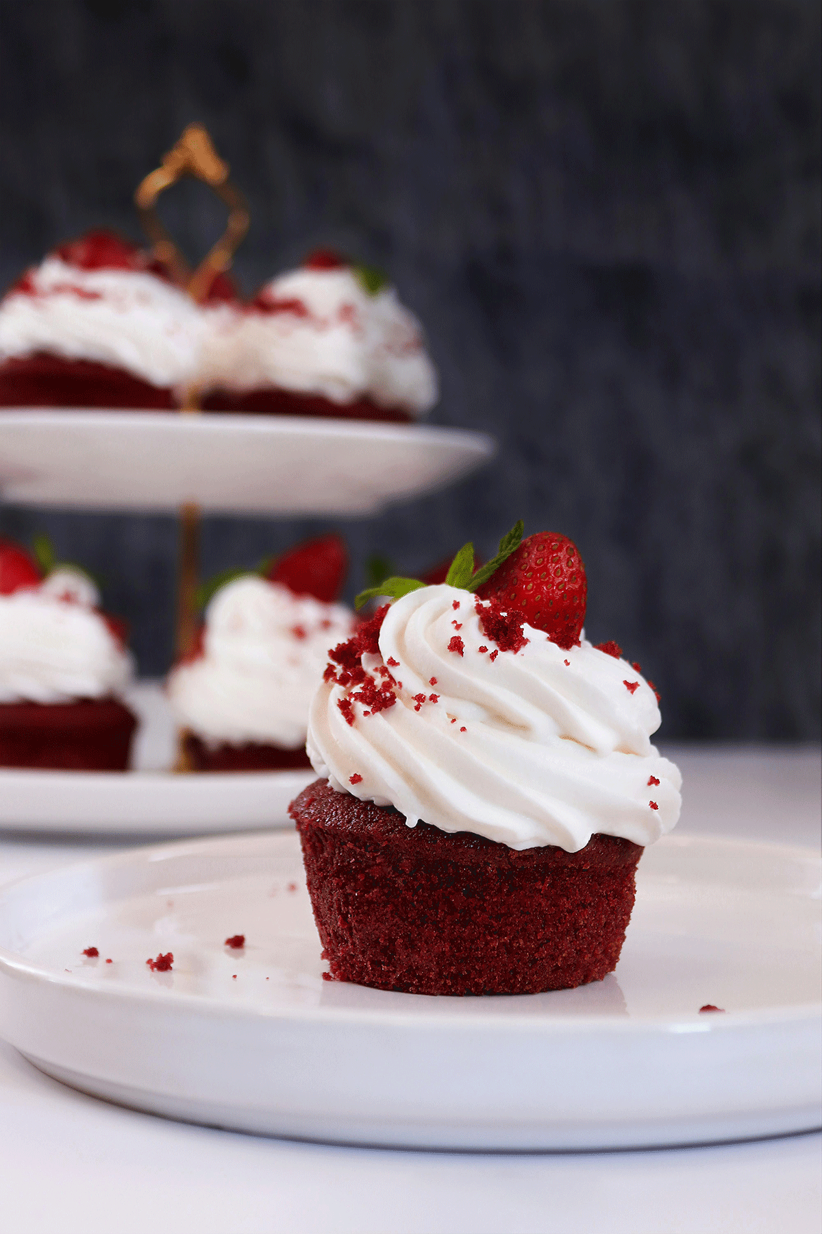 red velvet cupcake topped off with cream cheese frosting